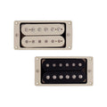 Two humbucker pickups with cream mounting rings, one with cream covers and one with black covers.