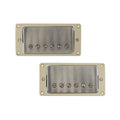 Two rectangular metal humbucker pickups with ivory mounting frames shown on a white background.