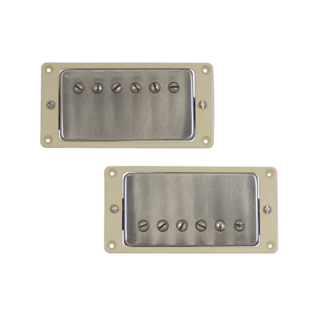 Two metal-covered humbucker pickups with cream mounting frames and visible mounting screws.
