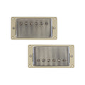 Two metal-covered humbucker pickups with cream mounting frames and visible mounting screws.