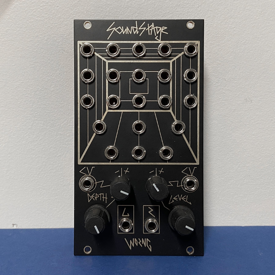 Front view of a black modular synthesizer panel with multiple audio jack sockets and four control knobs.