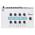 White synthesizer module labeled Xena with knobs, buttons, and a digital display showing parameter text.