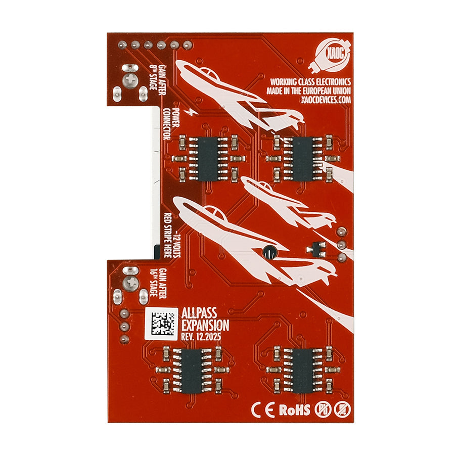Red printed circuit board with black chips and white graphics including planes and text markings