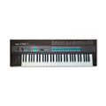 Black Yamaha DX7 digital programmable algorithmic synthesizer keyboard with sliders, buttons, and pitch and modulation wheels.