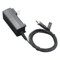 Black rectangular AC power adapter with coiled cable and green-tipped barrel DC plug.