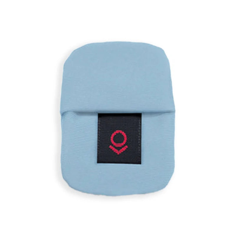 Light blue fabric cover with a black label featuring a red emblem in the center.