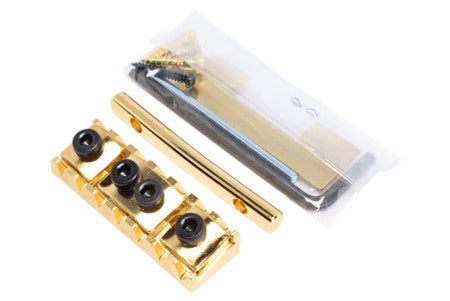 Gold-colored locking nut with related screws, Allen wrench, and metal bar on white background.