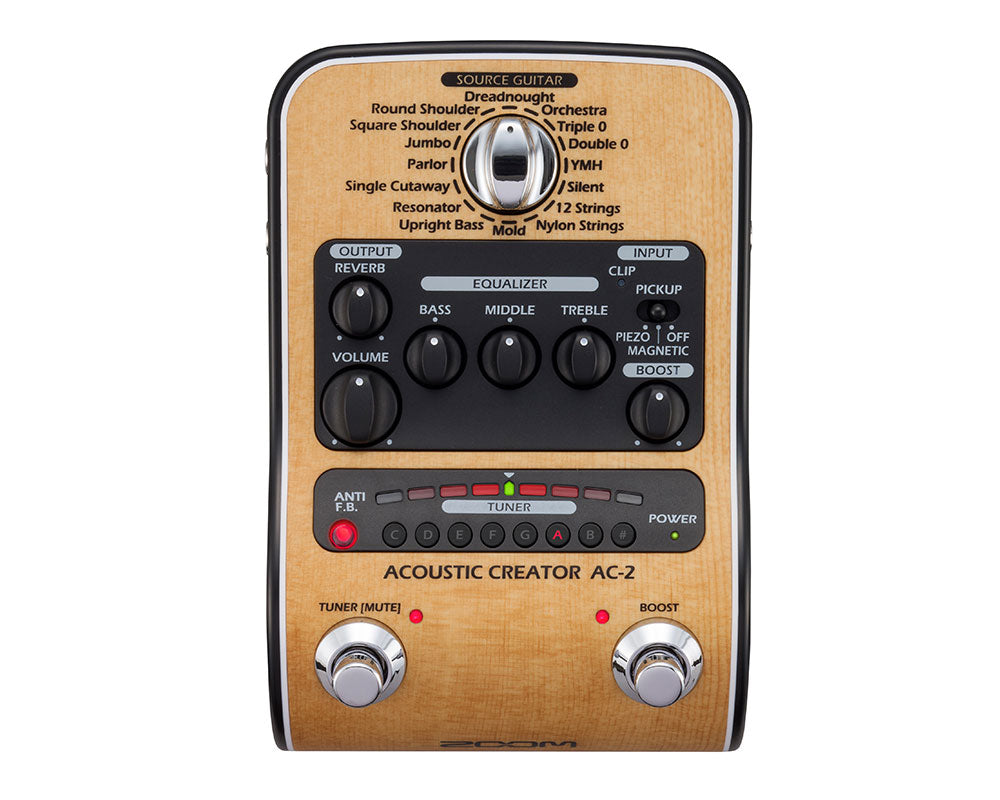 Top-down view of a light wood acoustic guitar preamp pedal with various knobs, switches, and two footswitches.