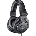 Black over-ear headphones with padded ear cups and headband, featuring wired cable and Audio Technica logo on ear cup.