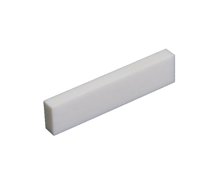 White rectangular flat-bottom solid piece likely used as a guitar nut part.
