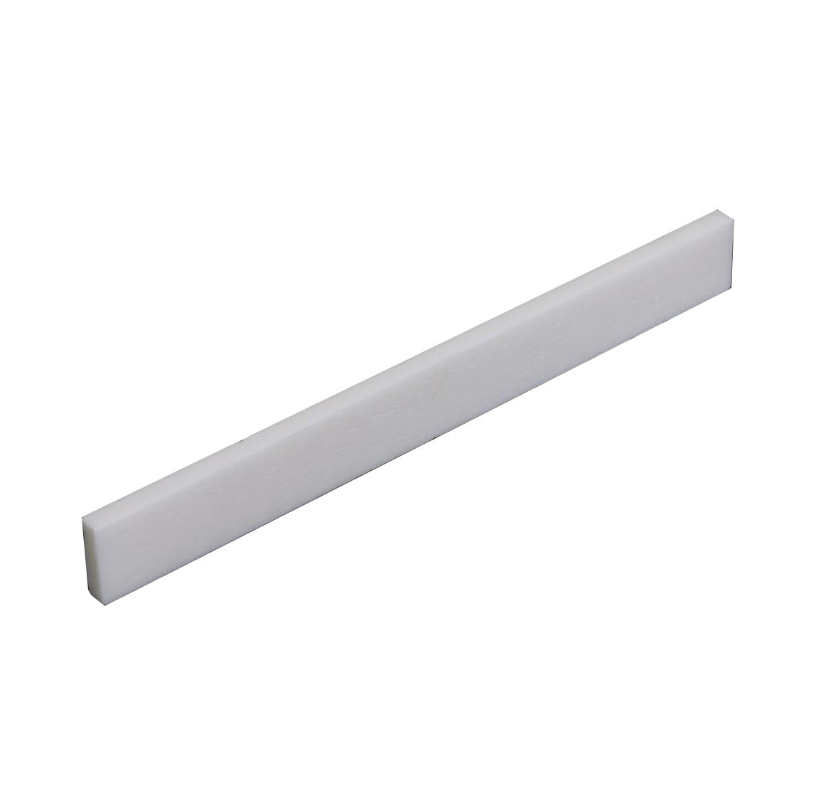White elongated rectangular flat-bottom blank bone saddle piece for an acoustic guitar.