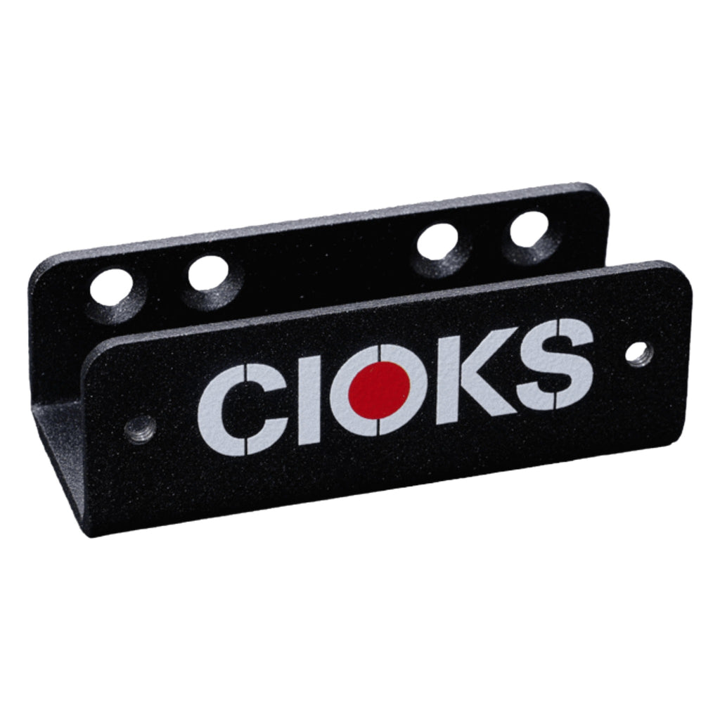 Black metal bracket with five circular holes and the word CIOKS printed in white with a red O.