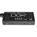 Black rectangular power supply unit with seven labeled outlets each with a toggle switch and power input on the side.