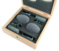 Two microphones with foam windshields and clips in a foam-lined wooden carrying case.