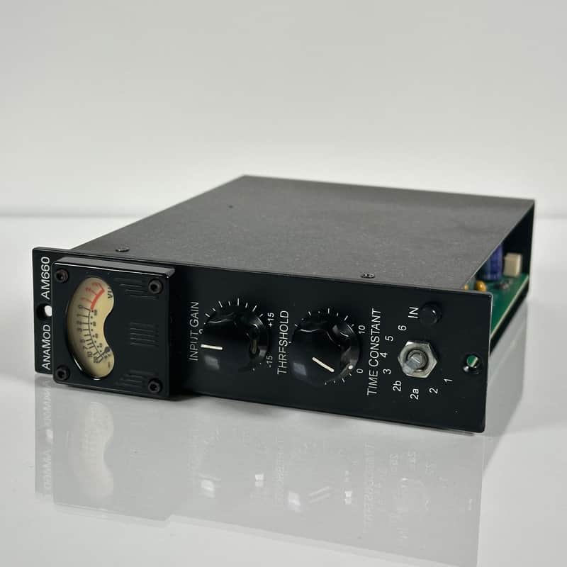 AnaMod AM660 500 Series module with a VU gain-reduction meter and front-panel controls labeled Input Gain, Threshold, and an eight-position Time Constant selector, plus an IN hard-bypass switch.