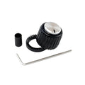 Black ribbed plastic knob with a silver metal top, a knurled ring, a small black cylindrical sleeve, and an Allen wrench on a white background.