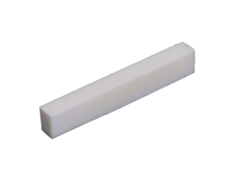 Rectangular white flat-bottom bone guitar nut blank shown against a white background.