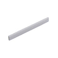 White flat rectangular piece likely used as a guitar saddle or similar part.