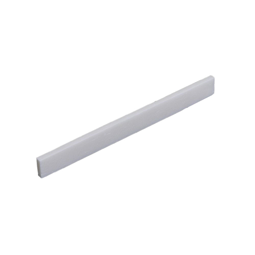 White flat rectangular piece likely used as a guitar saddle or similar part.
