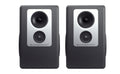 Pair of black and silver studio monitor speakers with visible woofers and tweeters, labeled BAREFOOT.