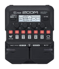 Top-down view of a black Zoom G1 Four multi-effects guitar pedal with knobs, buttons, and a digital screen.