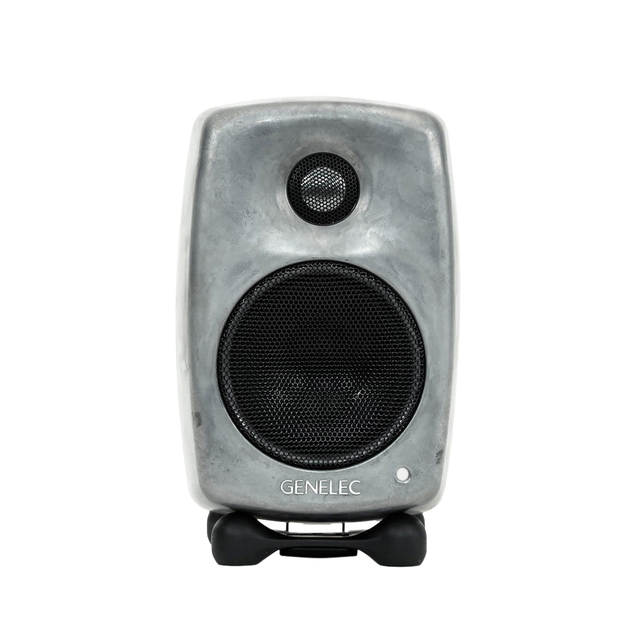 Front view of a compact grey Genelec speaker with protective black speaker grills on two drivers.