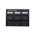 Black Zoom G3n multi-effects processor pedal with three footswitches and multiple control knobs visible.