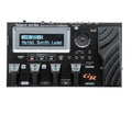 Black Roland GR-55 guitar synthesizer unit with screen, buttons, pedal, and multiple input/output ports.
