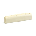 Off-white slotted guitar nut with six evenly spaced string slots.