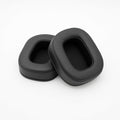 Two black oval-shaped ear pads made of leather or synthetic leather shown on a white background.