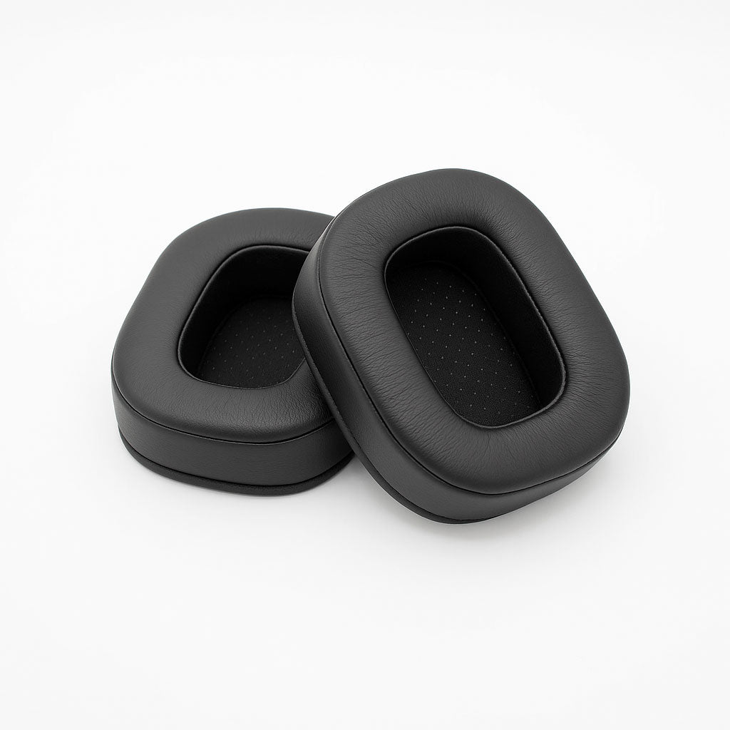 Two black oval-shaped ear pads made of leather or synthetic leather shown on a white background.
