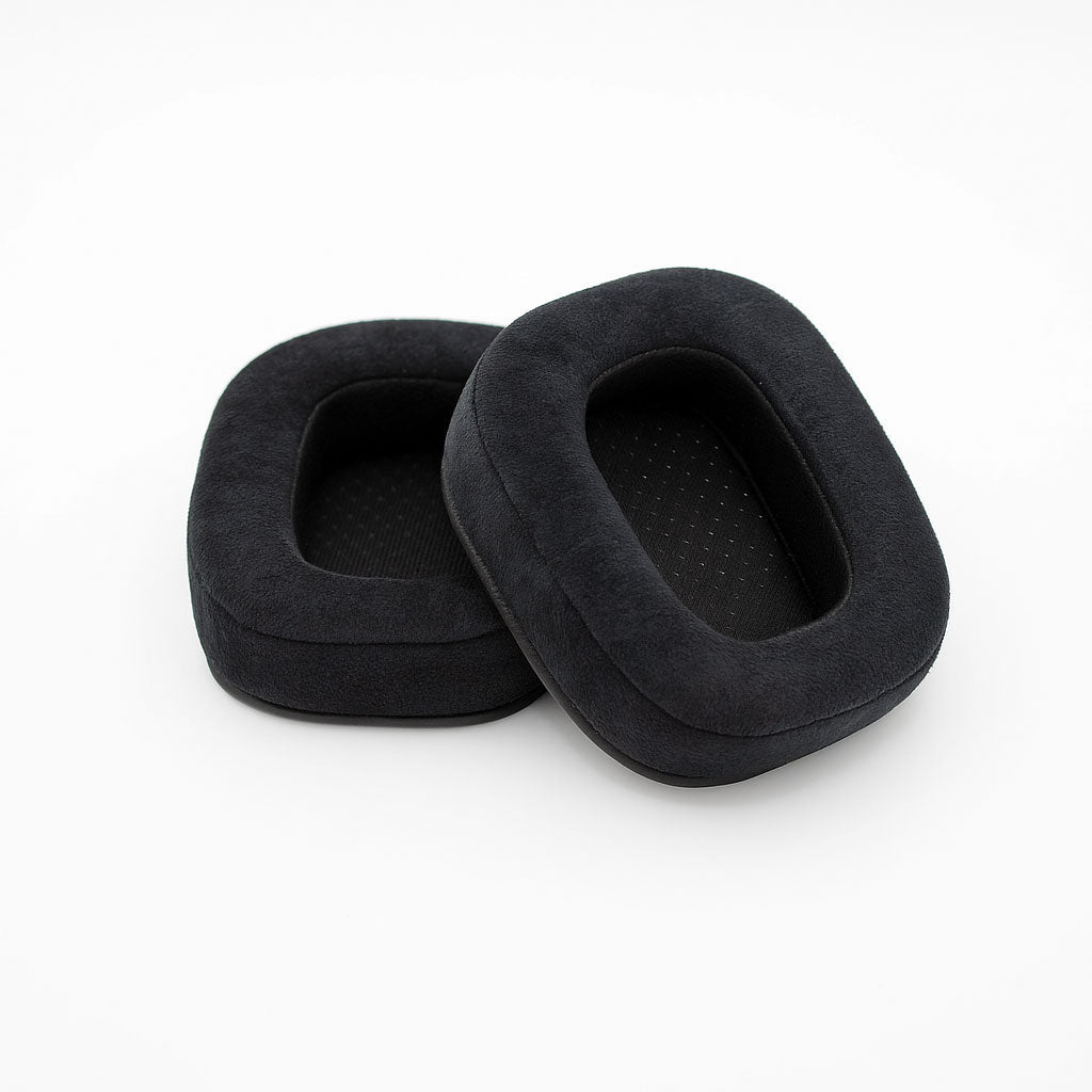 Pair of black rectangular velour ear pads for headphones on a white background.