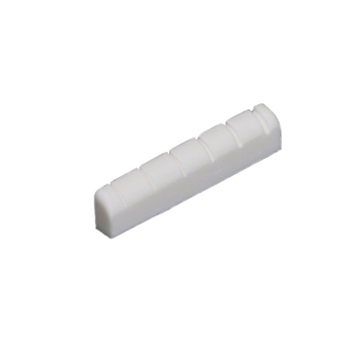 White slotted electric guitar nut shaped to fit a fretboard end.