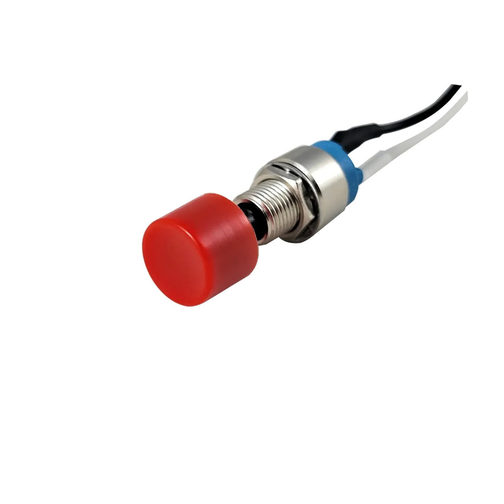 Push button switch with a red cap, metal body, and wires attached, isolated on a white background.