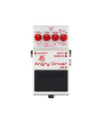 White guitar effects pedal with red knobs labeled Angry Driver JB-2 by JHS Pedals and Boss, featuring input, output, and remote jacks.