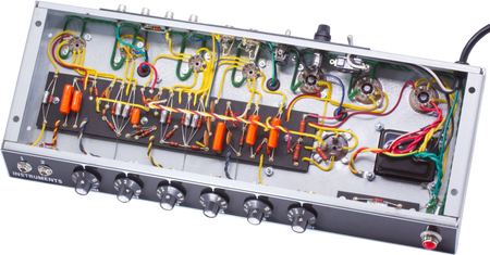 Open amplifier chassis showing internal wiring, components, and six black control knobs on front panel.