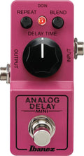 Pink Ibanez Analog Delay Mini guitar pedal with three control knobs, two audio jacks, a footswitch, and a red indicator light.