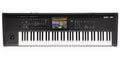 Black keyboard synthesizer workstation with 73 keys, multiple control knobs, faders, buttons, a joystick, and a color display screen.