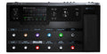 Top view of a black multi-effect guitar pedal with screen, knobs, buttons, and an expression pedal.