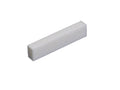 Single white rectangular block, likely a flat bottom blank nut part for string instruments.