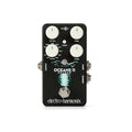 Black guitar effects pedal with four white knobs, a footswitch, and multiple 1/4 inch jacks.