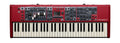 Red keyboard synthesizer with white and black keys and multiple control knobs, faders, and buttons.
