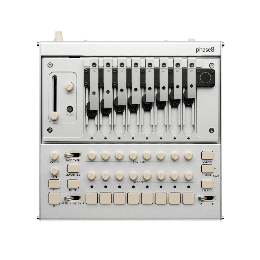 Top-down view of a silver synthesizer with numbered metal levers, multiple knobs, buttons, and labeled controls.
