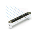 Silver metallic guitar bridge with six black saddles and two adjustment knobs, shown with blue strings.