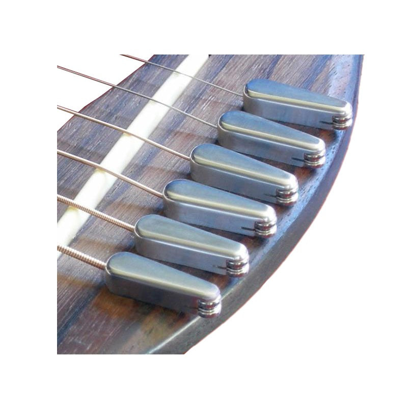 Metallic bridge pins installed in a wooden guitar bridge with strings attached