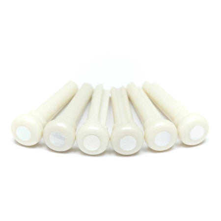 Six white plastic bridge pins each with a pearl-like white dot on top.