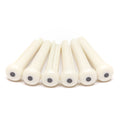 Six white pins with black circular inlays arranged in a row on a white background.