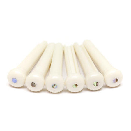 Six white bridge pins with iridescent dots arranged in a row on a white background.