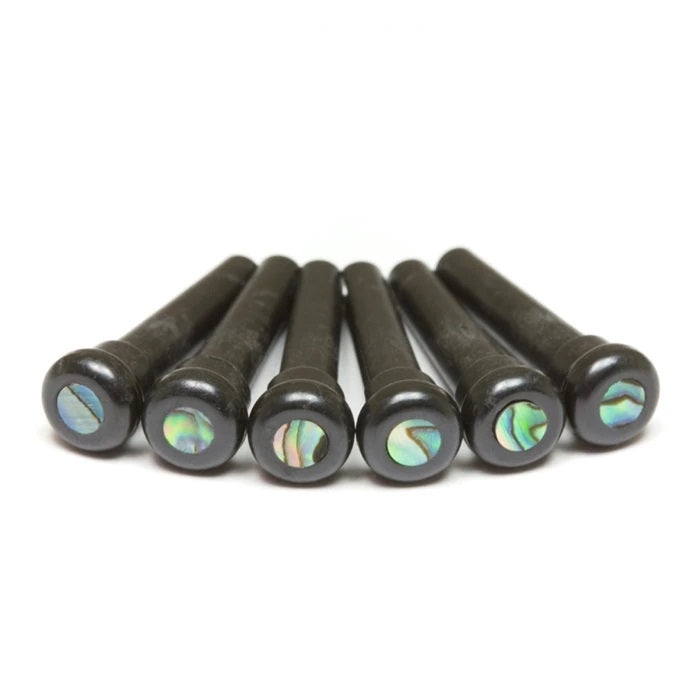 Six black bridge pins with iridescent circular inlays at the top arranged in a line