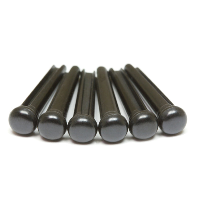 Six black cylindrical bridge pins with rounded tops arranged in a row.